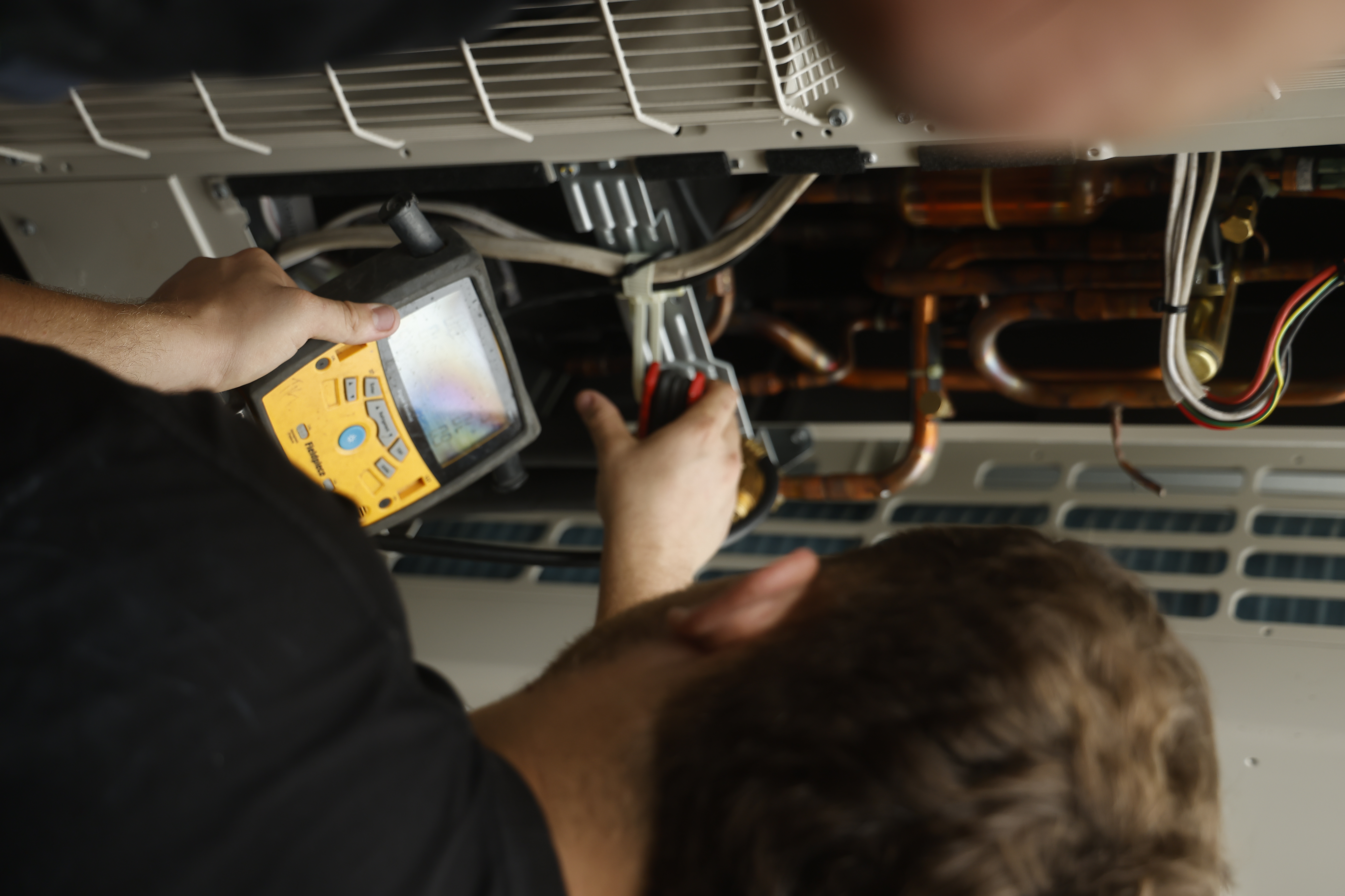 COLDCOAST technician servicing an air conditioning system