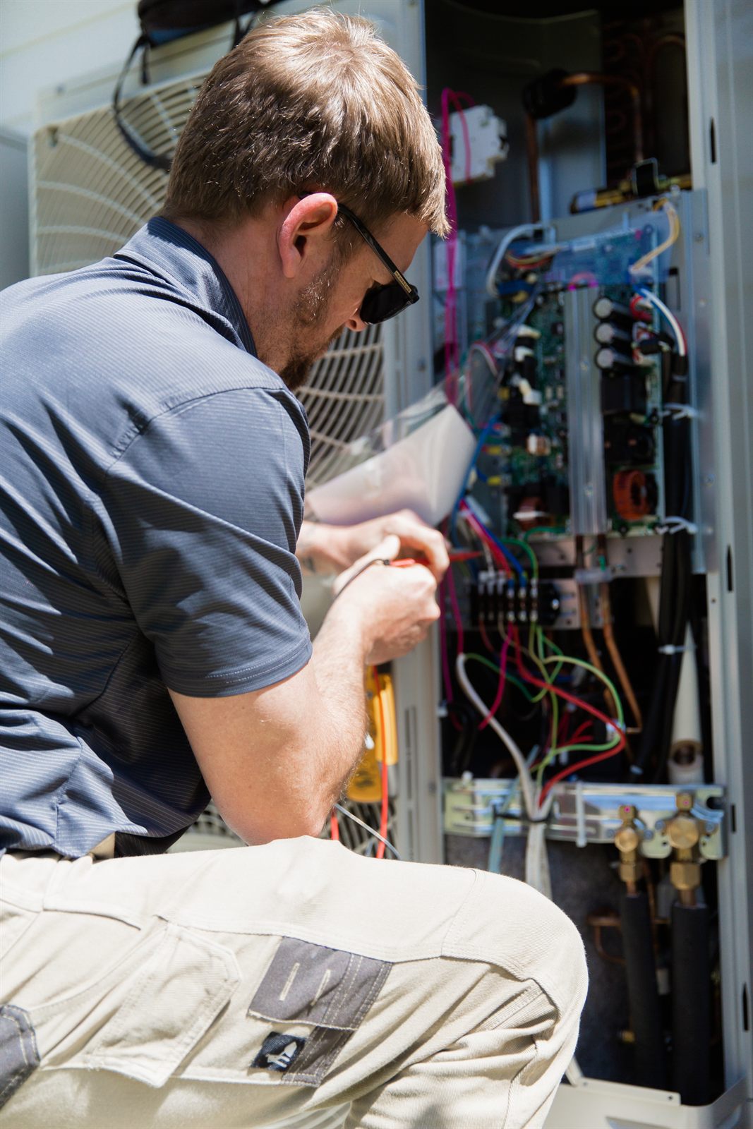 COLDCOAST service technician servicing an air conditioning unit